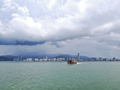 Penang and Malaysia Mainland sea channel with red ferry