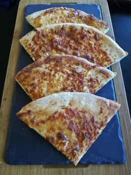 Mediterranean baked plain naan served on volcanic hot plate.