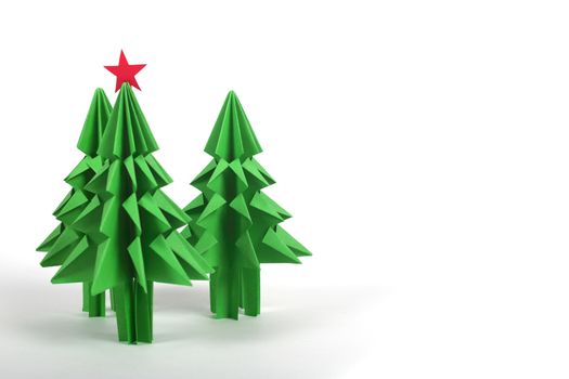 Origami Christmas trees of green craft paper isolated on white background