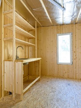 Construction of a country house. Installed homemade yet stylish wood kitchen