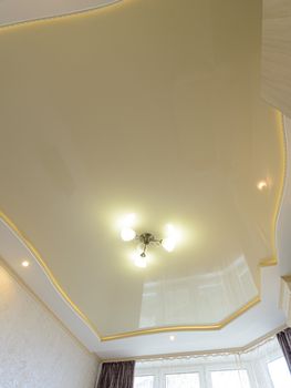 View of the beautiful rich stretch ceiling of the original form in the interior of the bedroom