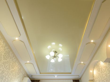 Very beautiful golden ceiling in the interior of the apartment