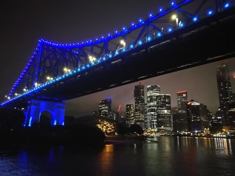 Iconic Brisbane Story Bridge with city skyscrapers at night