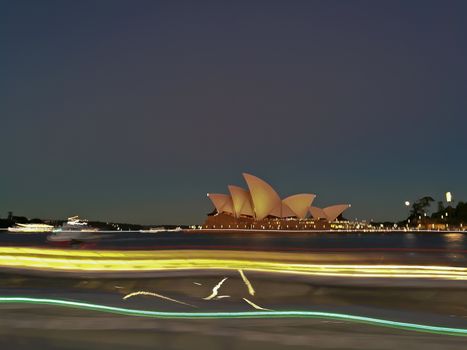 SYDNEY, AUSTRALIA - MAY 5, 2018: Sydney Opera House blur motion of a famous Sydney city ferry in late afternoon and twililght sky.