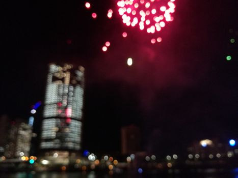 Defocused abstract scene of riverside firework in city center at night to celebrate festive event