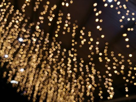 Defocused twinkle sparkling golden bokeh light background