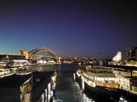 SYDNEY, AUSTRALIA - MAY 5, 2018: Sydney Harbour Bridge and Circular Quay, which is a landmark near the famous Sydney Opera House at night