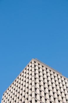 Tall and high classic corporate office building with blue sky and no cloud