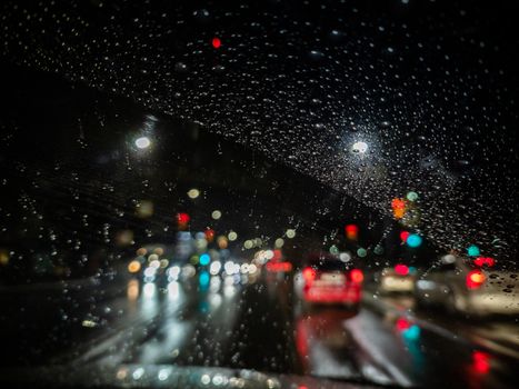 defocused photo of night driver view on city from right steering car - short sightness problem