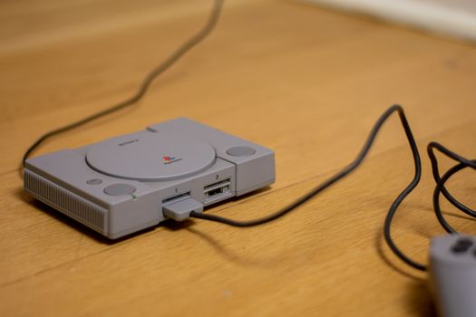 The Playstation Classic Edition. A recreation model of the original Playstation, On a Wooden Floor.
