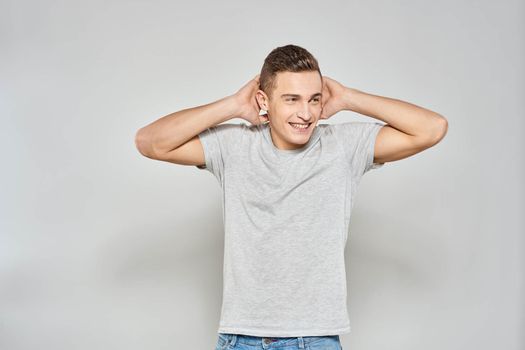 handsome man in light t-shirt cropped view emotion studio isolated background. High quality photo