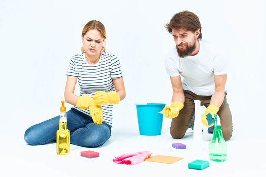 Young couple wash floors at home interior light background lifestyle. High quality photo