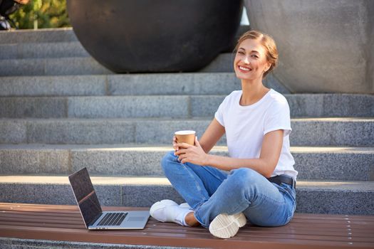 Businesswoman sitting stairs summer park using laptop Business persone working remote. Outdoor. Successful Young european caucasian woman freelancer meeting online