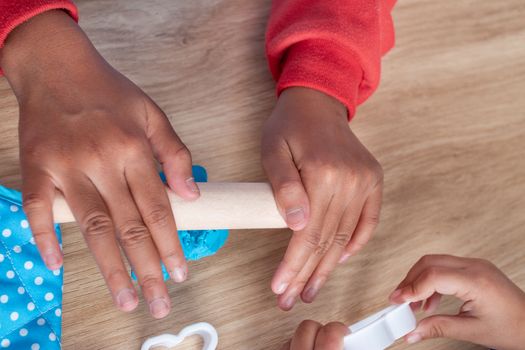 Children's hands and simulation cooking toys in the kitchen counter