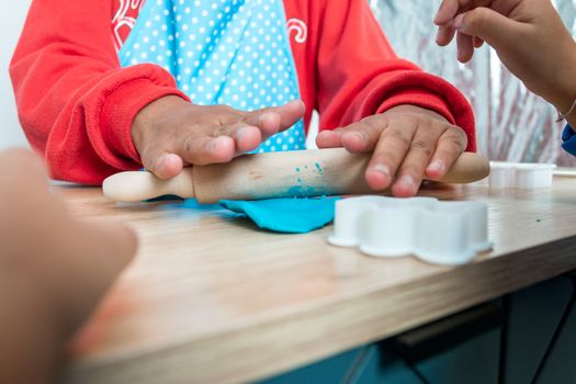 Children's hands and simulation cooking toys in the kitchen counter