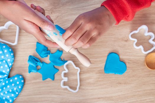 Children's hands and simulation cooking toys in the kitchen counter