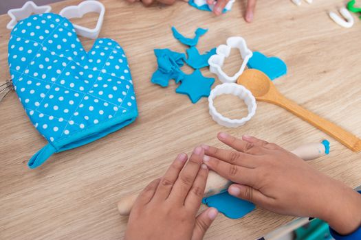 Children's hands and simulation cooking toys in the kitchen counter