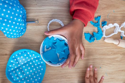Children's hands and simulation cooking toys in the kitchen counter