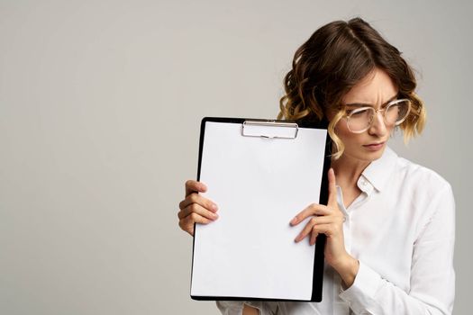 Business woman with folder of documents in hands on gray background cropped view of work. High quality photo