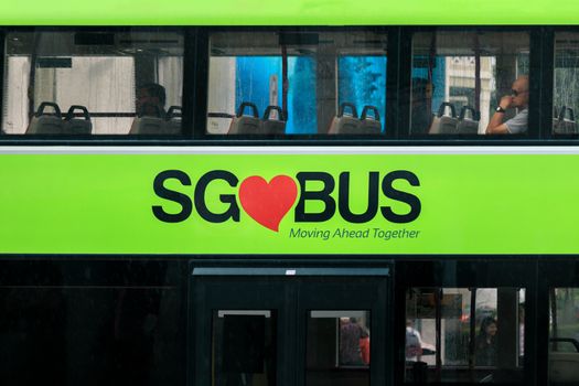 Close up of SG bus logo on green Double Decker Bus, operated by SBS Transit, on street in Singapore. SBS Transit is the largest public bus operator in Singapore.