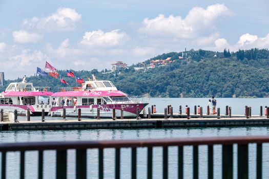 Tourists walk on pier for Hop-On Hop-Off Boat at Sun Moon Lake, the largest lake in Taiwan and tourist attraction. There are 3 main piers at Sun Moon Lake