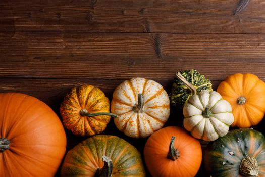 Many orange pumpkins on wooden background , Halloween concept , top view with copy space