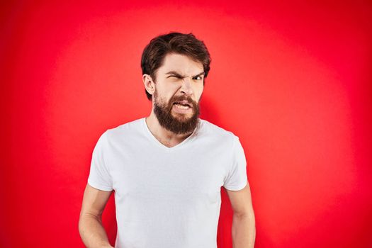 man in t-shirt gesturing with his hands dissatisfaction studio red uniform. High quality photo