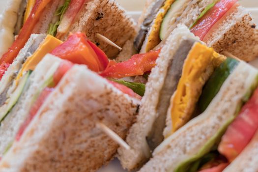 Vegetarian sandwiches. Healthy toasts with omelette, peppers, courgettes and tomatoes for breakfast or lunch. Plant-based diet. Whole food concept. Close-up.