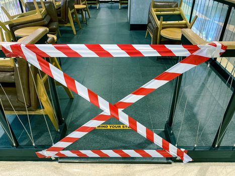 line strip or warning tape at restaurant to prohibit customer during outbreak, sign of no entry to protect spread of covid-19