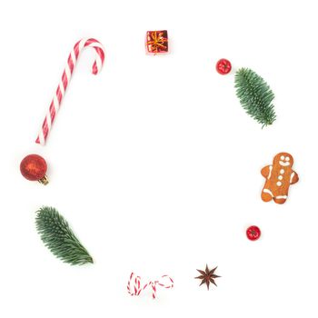 Christmas decorative minimalistic conceptual wreath with noble fir tree twigs and baubles objects design top view isolated on white background. New Year concept.