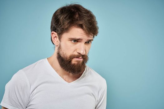 Bearded man emotions white t-shirt lifestyle gestures with hands blue backgrounds. High quality photo