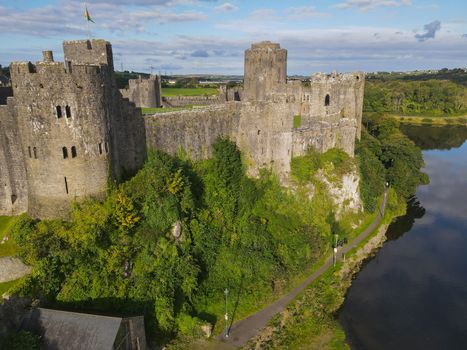 The medieval Pembroke Castle Wales surrounded by a moat and overlooked the market town of Pembroke. This fortress is an historical building and the start of the Tudor Dynasty. Ariel View