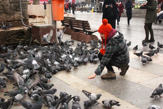 Young girl portrait on the urban street with birds