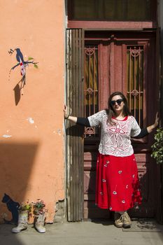 Young woman portrait, beautiful girl, pretty and cute girl on the building and architecture door background. Tourist scene.