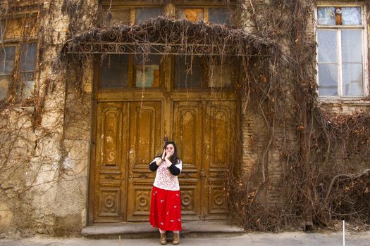 Young woman portrait, beautiful girl, pretty and cute girl on the building and architecture door background. Tourist scene.