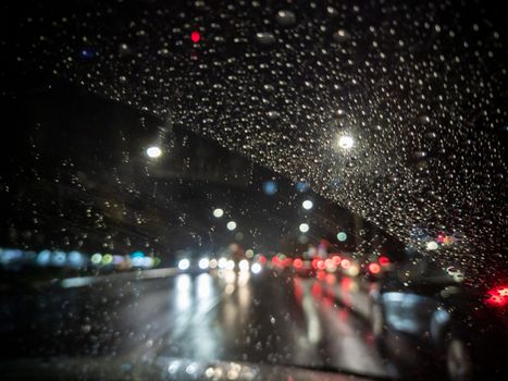 defocused photo of night driver view on city from right steering car - short sightness problem
