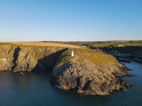 The Entrance From The Sea To Porthgain Harbour in Pembrokeshire, Wales, UK is Marked By White Pillars High On The Cliffs Of The Coast