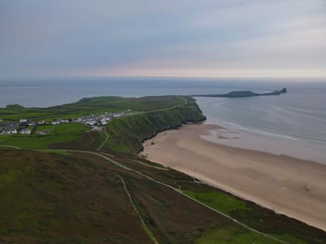 Ocean view out towards Worms Head from Rhossili Bay Beach, Gower, Wales, UK. Stunning coastal views overlooking the sea!