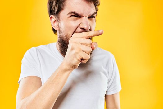 bearded man gesturing with hands studio lifestyle discontent yellow background. High quality photo