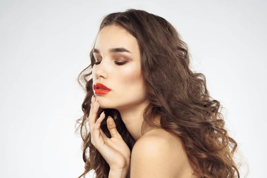 Elegant woman with bare shoulders red lips glamor attractive look cropped look. High quality photo
