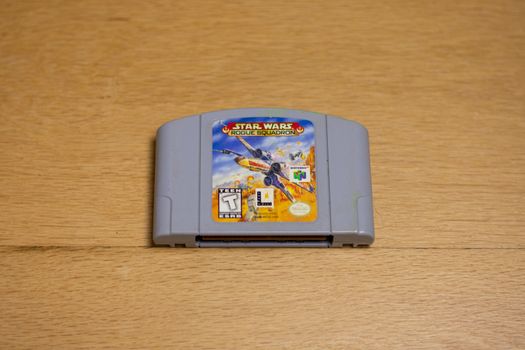 A Cartridge of Star Wars Rogue Squadron for the Nintendo 64 on a wood floor.