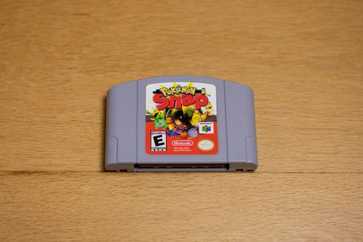 A Cartridge of Pokemon Snap for the Nintendo 64 on a wood floor.