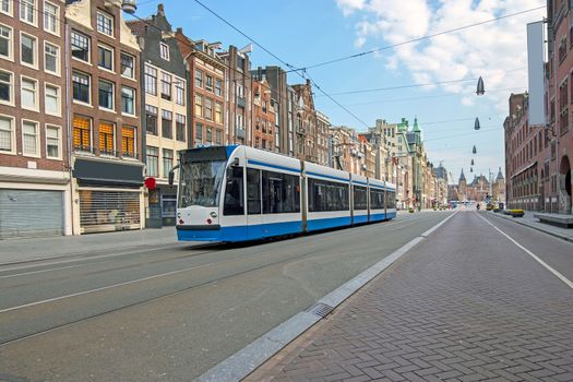 Tram driving at Damrak in Amsterdam the Netherlands