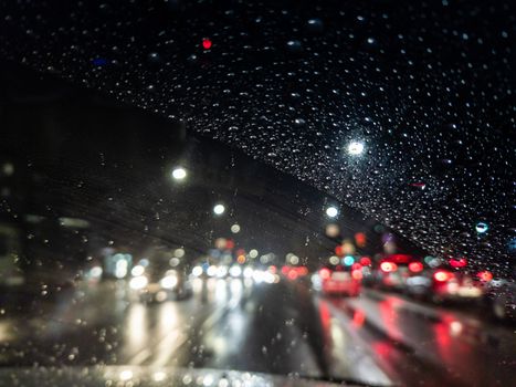 defocused photo of night driver view on city from right steering car - short sightness problem