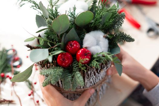 Creating Christmas floral arrangement with carnations, chrysanthemum santini flowers and fir. Floral Design basics