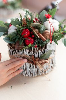 Creating Christmas floral arrangement with carnations, chrysanthemum santini flowers and fir. Floral Design basics