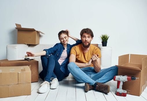 Man and woman with empty boxes Moving to an apartment indoor interior. High quality photo