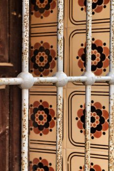 Beautiful tiled window with rusty iron lattice in Lisbon, Portugal