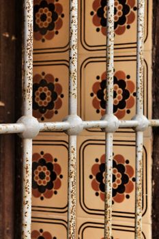 Beautiful tiled window with rusty iron lattice in Lisbon, Portugal