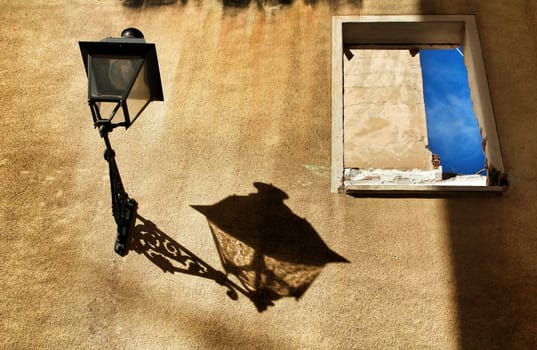 Old and damaged facade in Lisbon. Vintage Street light on the wall